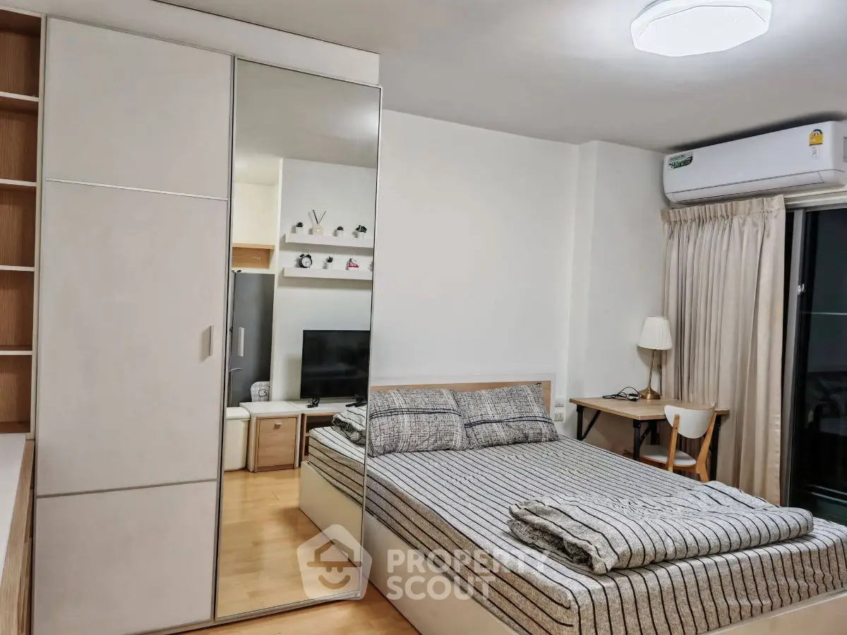 Modern bedroom with mirrored wardrobe and cozy decor