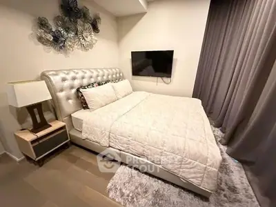 Luxurious bedroom with plush bed and modern decor in elegant apartment