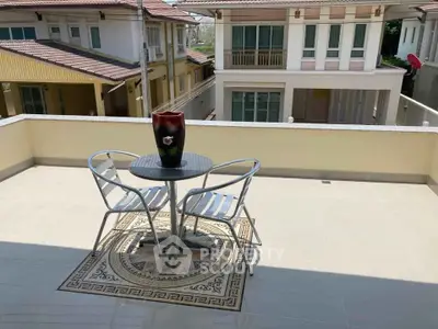 Spacious balcony with stylish outdoor seating and scenic neighborhood view, perfect for relaxation and entertaining.