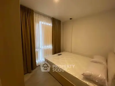 Cozy bedroom with natural light and elegant curtains