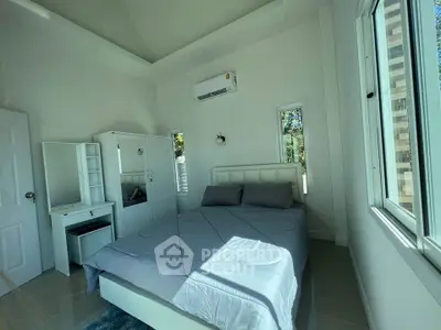 Modern bedroom with large windows and minimalist furniture