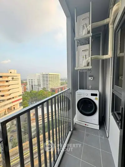 Modern balcony with washer and dryer overlooking cityscape, ideal for urban living.