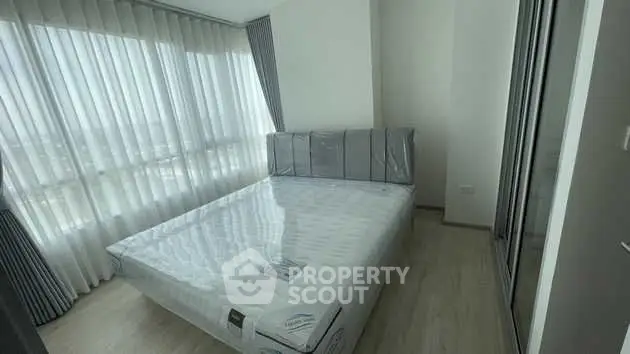 Bright and airy bedroom with large windows and modern furnishings