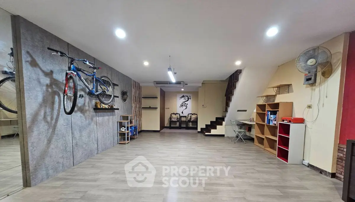 Spacious modern living area with wall-mounted bike and stylish decor