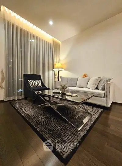 Elegant living room with modern decor and cozy lighting, featuring a stylish sofa and chic coffee table.