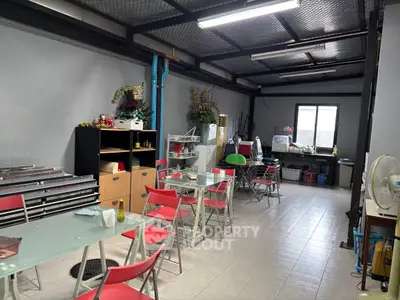 Spacious storage room with folding chairs and tables, ideal for multipurpose use.