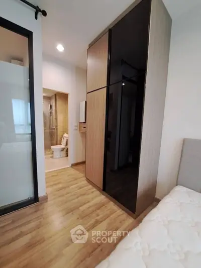 Modern bedroom with sleek wardrobe and ensuite bathroom