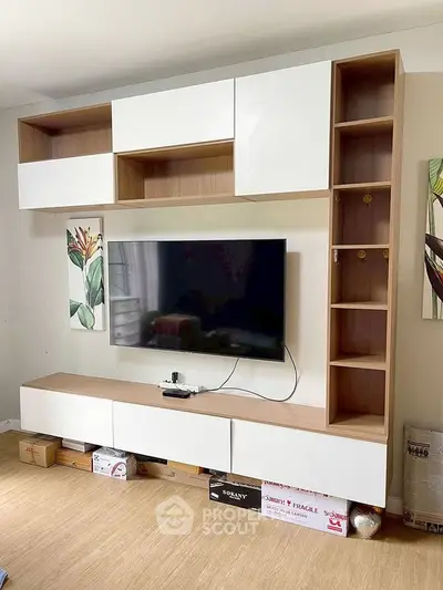 Modern living room with sleek TV unit and stylish wall decor