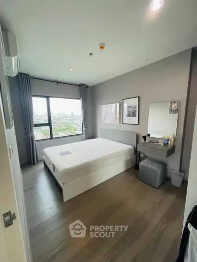 Modern bedroom with city view, featuring sleek decor and ample natural light.