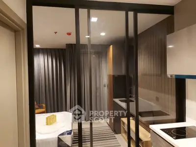 Modern studio apartment with sleek kitchen and cozy bedroom