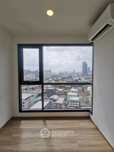 Spacious high-floor corner unit with expansive city views through large windows, offering natural light and modern living in a prime location.