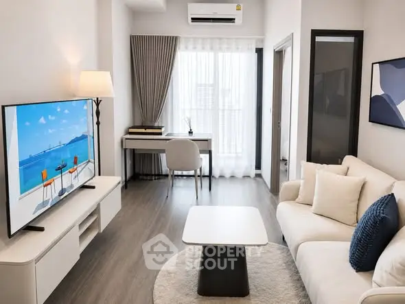 Modern living room with stylish decor and natural light, featuring a cozy sofa and a sleek TV setup.