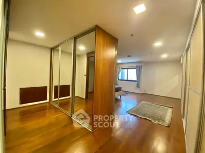 Spacious modern living room with wooden flooring and large windows