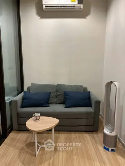 Cozy living room with modern sofa, air conditioner, and stylish air purifier.