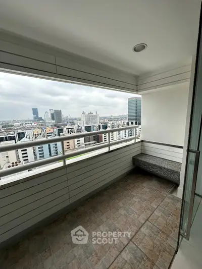 Spacious balcony with stunning city skyline view, perfect for relaxation and enjoying urban living.