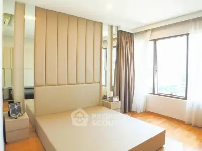 Modern bedroom with large windows and stylish decor, featuring a comfortable bed and elegant curtains.