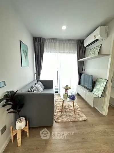 Modern living room with sleek furniture and natural light, featuring a cozy sofa and stylish decor.