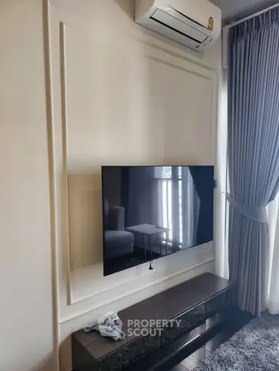 Modern living room with wall-mounted TV and air conditioning unit