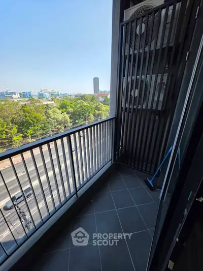 Spacious balcony with city view, perfect for relaxation and enjoying the skyline.