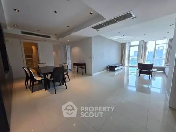 Spacious modern living room with dining area and city view, perfect for urban living.