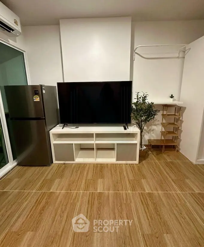 Modern living room with sleek TV setup and stylish wooden flooring