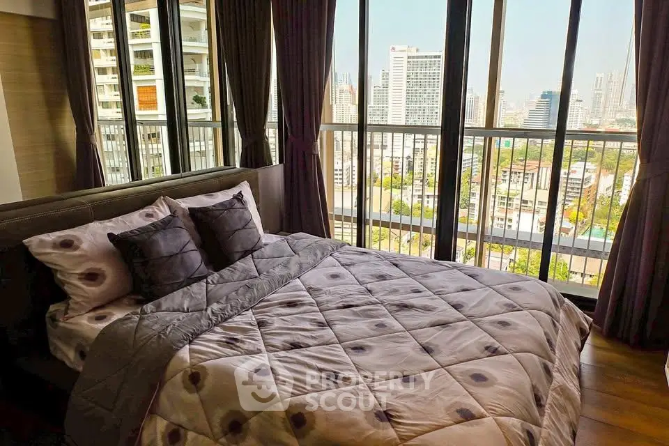 Luxurious bedroom with stunning city view from floor-to-ceiling windows in modern high-rise apartment.