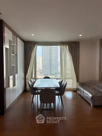 Spacious living room with city view, elegant dining area, and modern furnishings.