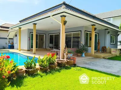 Charming single-story home with pool and lush garden, perfect for family living.