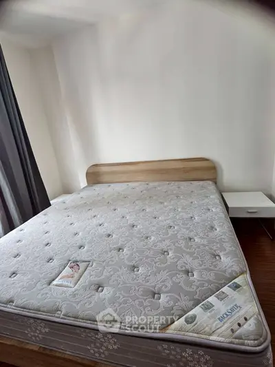 Spacious bedroom with modern bed and natural light, perfect for relaxation.
