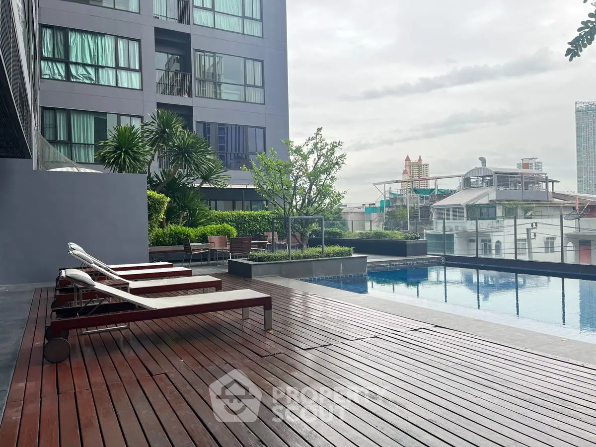 Luxurious rooftop pool with city view and modern lounge chairs