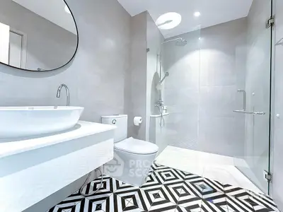 Modern bathroom with sleek design and geometric floor tiles