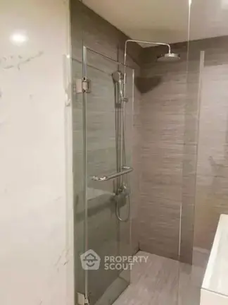 Modern bathroom with glass shower enclosure and sleek tile design
