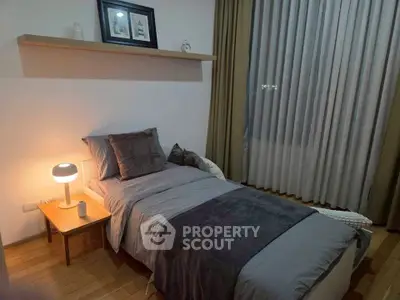 Cozy bedroom with modern decor and ambient lighting, perfect for relaxation.