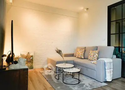 Stylish modern living room with cozy gray sofa and chic decor