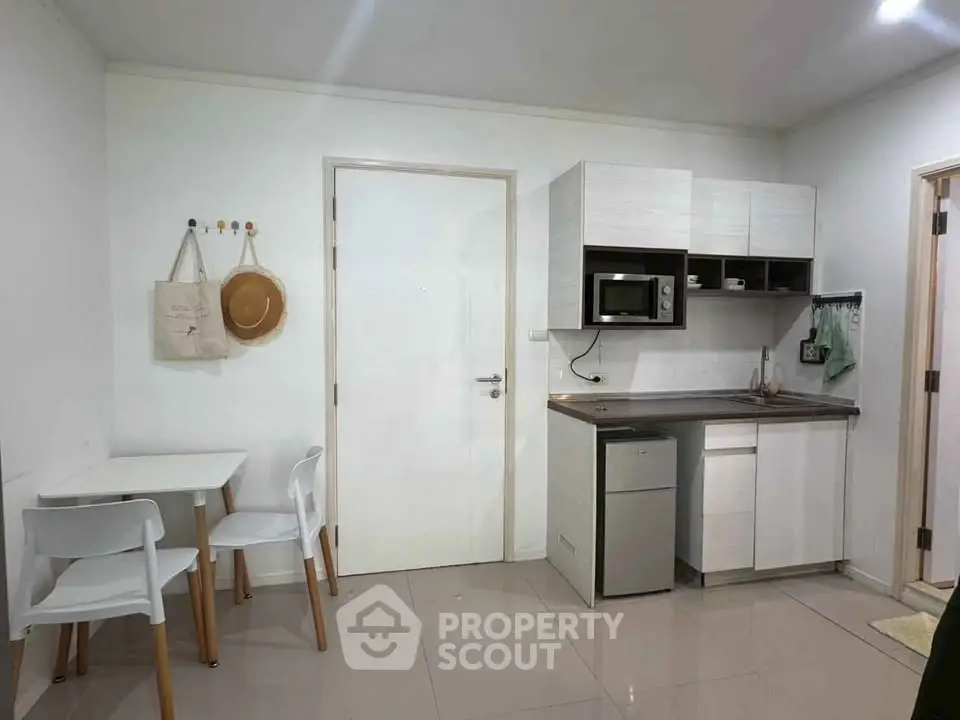 Modern compact kitchen with dining area in a cozy apartment