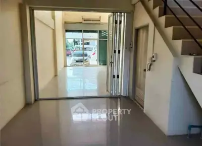 Spacious open-plan interior with modern staircase and garage view