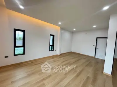 Spacious modern living room with wooden flooring and recessed lighting