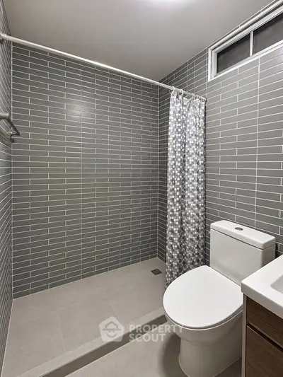 Modern bathroom with sleek gray tiles and stylish shower curtain
