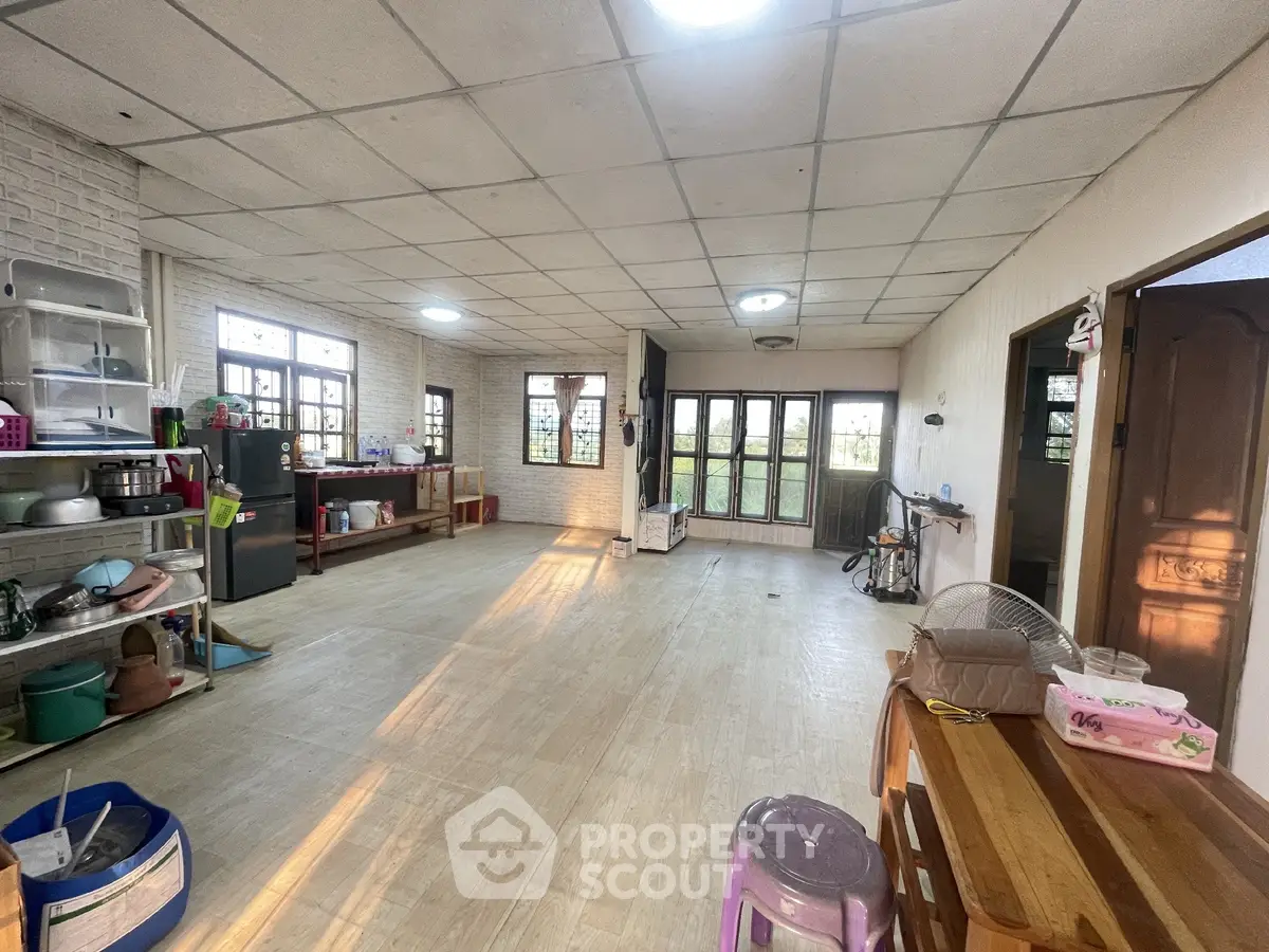 Spacious open-plan kitchen with ample natural light and modern appliances