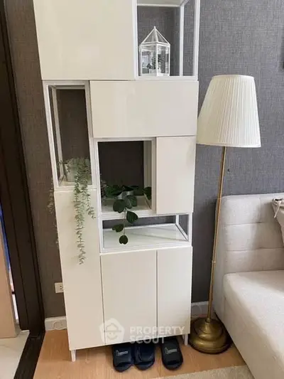 Modern living room with stylish white shelving unit and elegant floor lamp