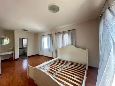 Spacious bedroom with elegant bed frame and natural light