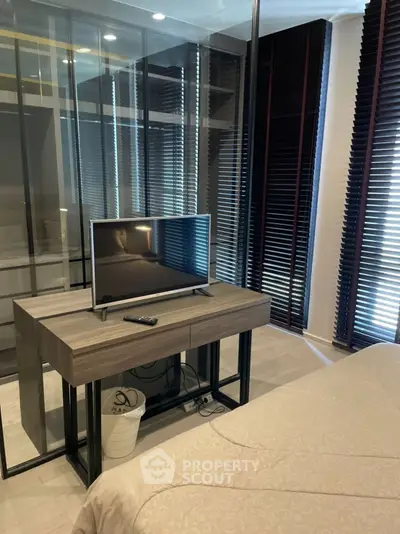 Modern bedroom with sleek TV setup and stylish blinds