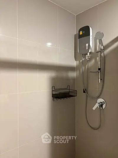 Modern bathroom with sleek shower unit and tiled walls, perfect for a contemporary home.