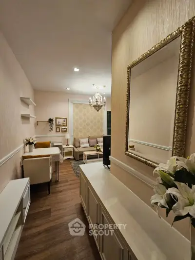 Elegant living room with chandelier and stylish decor in modern apartment