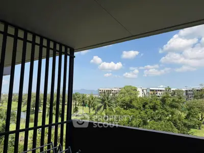 Spacious balcony with scenic view of lush greenery and blue sky