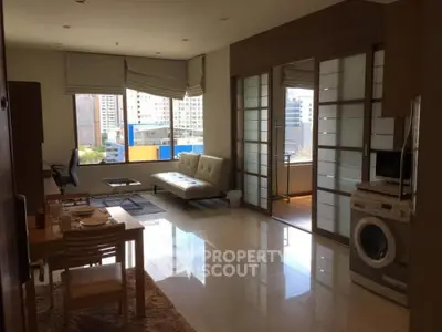 Modern living room with city view and washing machine in open layout