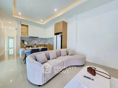 Modern open-plan living room with elegant kitchen and stylish furniture