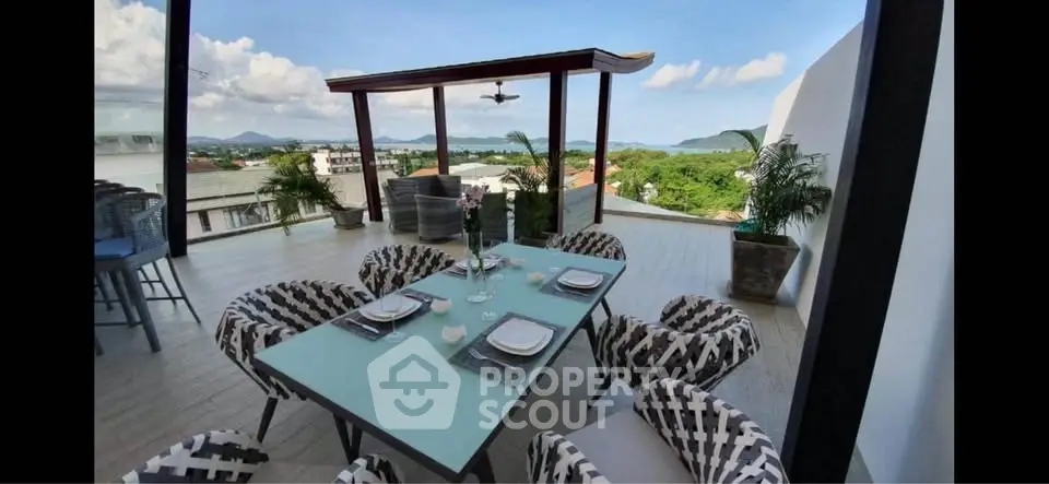Stunning rooftop terrace with panoramic views and stylish outdoor dining area.