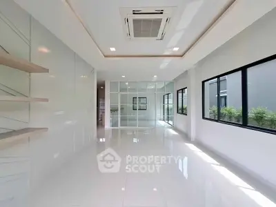 Spacious modern living room with large windows and sleek design.