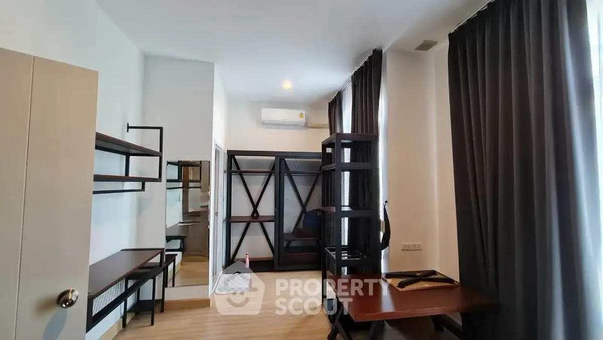 Modern study room with sleek furniture and ample natural light, perfect for productivity and comfort.